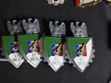 several different badges are displayed on a black surface