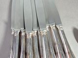 a lot of knives that are sitting on a table