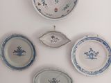 five plates and a bowl on a white surface