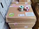 several boxes of spools are stacked on top of each other in a warehouse