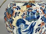 a blue and white vase with an angel on it