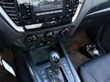 a dashboard of a car with a radio and a steering control