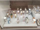 a lot of watches on display in a glass case