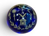 a glass ball with a design on it on a white surface