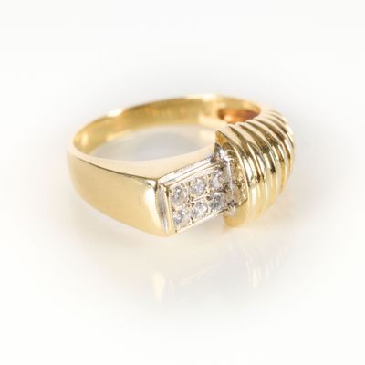 an image of a yellow gold ring with two diamonds on it