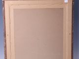 painting on a wooden easel against a wall with a blue background