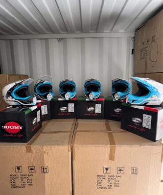 several boxes of helmets are stacked on top of each other