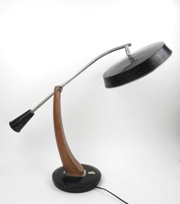 a black lamp with a wooden base on a white background