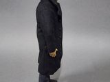 a figurine of a man in a black coat and boots