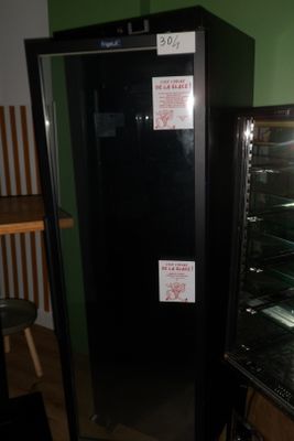 a microwave oven sitting on top of a black shelf