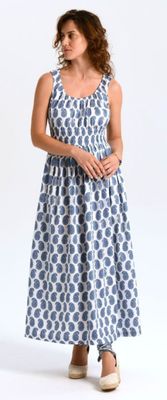 the woman is wearing a blue and white dress with circles on it