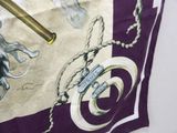 a purple and white scarf with a picture of a man on a horse