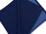 a navy and blue pocket square folded on top of a white background