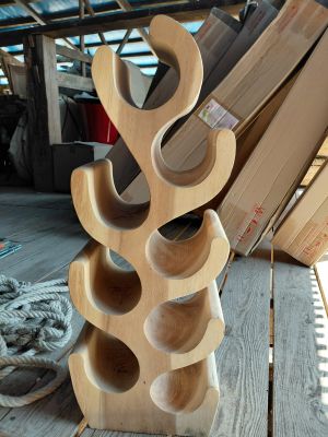 a wooden wine rack that is on a wooden table