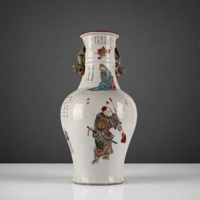 a white vase with a painting on it sitting on a table