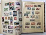 an open book with stamps on it on a table