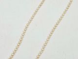 a white pearl necklace with a silver clasp on a white background