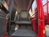 a red truck with a black seat in the back of it