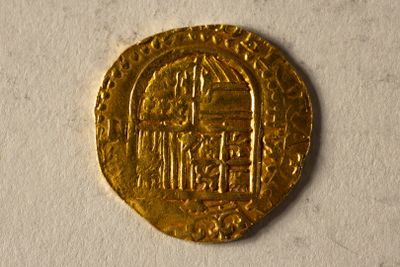 une image représentant une pièce d'or sur laquelle figure l'effigie d'un bâtiment
