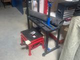 a woman that is working on a machine in a garage
