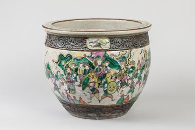 a white vase with a green and pink design on it