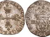 a silver coin with a crown on top of it