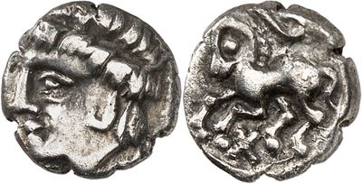 a close up of a coin with a face on it