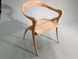 a wooden chair that is sitting on a white floor