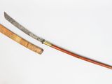 a knife and a wooden handle on a white surface