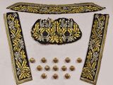 a picture of a black and gold dress with gold buttons
