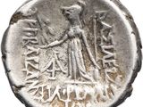 a silver coin with a woman holding a sword on it