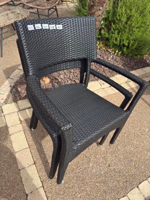 a black chair that is sitting on a patio