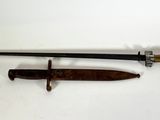 an old sword with a wooden handle on a white surface