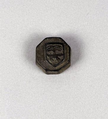a close up of a small metal object on a white surface