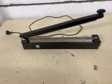 a close up of a black hand held sealer on top of a table