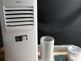 a small air conditioner sitting on a table next to other items