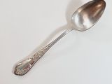 a spoon that is sitting on a white table