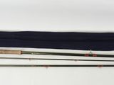 a picture of a pair of fishing rods on a white surface