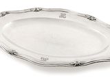 a silver plate with a decorative design on the edge
