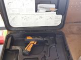 a box with a gun inside of it on a table