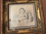 an old picture of a baby sitting in a chair with a teddy bear