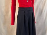 a mannequin wearing a red top and black skirt