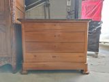a wooden chest of drawers with a marble top