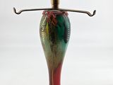 a red and green lamp that is on a table