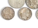 six different types of silver coins are shown on a white surface
