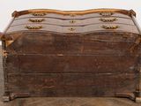 an old wooden chest sitting on top of a floor next to a wall