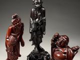three chinese carved figurines of a man and a woman