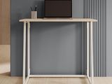a desk with a laptop on top of it in front of a gray wall