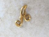 a close up of a gold plated metal object on a white surface