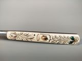 a close up of a knife with a design on it